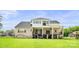 A spacious backyard featuring a two-story home with walk out basement and a serene outdoor setting at 1702 Batson Creek Ln, Weddington, NC 28104