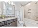 Bathroom featuring granite countertop, a large mirror, and bathtub-shower combination at 1702 Batson Creek Ln, Weddington, NC 28104