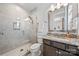 Modern bathroom showcasing a glass-enclosed shower and granite countertop sink at 1702 Batson Creek Ln, Weddington, NC 28104