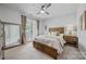 Cozy bedroom with a wooden bed frame, bedside table, full mirror, and access to a balcony at 1702 Batson Creek Ln, Weddington, NC 28104