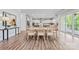 Open floor plan with dining area, and kitchen, boasting recessed lights, wood floors, and neutral colors at 1702 Batson Creek Ln, Weddington, NC 28104