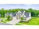 Beautiful two-story home with white brick, black roof, green shutters, and a three car garage at 1702 Batson Creek Ln, Weddington, NC 28104