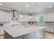 The gourmet kitchen offers granite countertops, stainless steel appliances, and a large center island perfect for entertaining at 1702 Batson Creek Ln, Weddington, NC 28104
