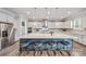Large kitchen island with stone countertops, pendant lighting, stainless appliances, and barstool seating at 1702 Batson Creek Ln, Weddington, NC 28104