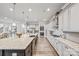Spacious kitchen with large center island, stainless appliances, light cabinetry and wood floors at 1702 Batson Creek Ln, Weddington, NC 28104