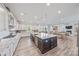 Bright, modern kitchen with large center island, stainless appliances, and adjacent dining area at 1702 Batson Creek Ln, Weddington, NC 28104