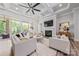 The living room features a coffered ceiling, a fireplace, a TV, and access to the outdoor porch at 1702 Batson Creek Ln, Weddington, NC 28104