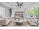 Open floor plan living room features a coffered ceiling, neutral decor, and easy access to the kitchen at 1702 Batson Creek Ln, Weddington, NC 28104