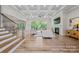 Spacious living room with coffered ceiling, wood floors, fireplace, and large windows overlooking backyard at 1702 Batson Creek Ln, Weddington, NC 28104