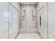 This is an open shower with dual shower heads, a built-in bench, and tiled walls at 1702 Batson Creek Ln, Weddington, NC 28104