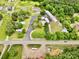 Aerial view of homes and garages with mature trees, showcasing ample space and a mix of residential and commercial potential at 1733 S Nc 16 Business Hwy, Stanley, NC 28164
