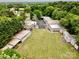 Aerial view of houses and garages, nestled among lush greenery, highlighting its serene and private setting at 1733 S Nc 16 Business Hwy, Stanley, NC 28164