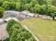Aerial view of property with garages and houses, showcasing ample outdoor storage and a well-maintained grassy area at 1733 S Nc 16 Business Hwy, Stanley, NC 28164