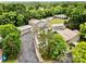 Aerial view of houses and multiple garages surrounded by lush trees, offering a serene and private setting at 1733 S Nc 16 Business Hwy, Stanley, NC 28164