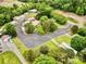 Aerial view of homes and storage units surrounded by a mix of mature trees and grassy areas, highlighting both residential and storage at 1733 S Nc 16 Business Hwy, Stanley, NC 28164