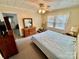 Neutral bedroom featuring a ceiling fan, dresser, and natural light from a window at 1733 S Nc 16 Business Hwy, Stanley, NC 28164