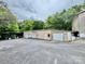 Exterior shot of outbuilding featuring garage doors and parking, with mature shade trees in the background at 1733 S Nc 16 Business Hwy, Stanley, NC 28164
