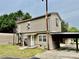 Two-story home with wood siding, carport, and stairway to a private entrance at 1733 S Nc 16 Business Hwy, Stanley, NC 28164