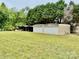 Well kept grassy lot features a multi-stall outbuilding with roll-up doors for storage and equipment at 1733 S Nc 16 Business Hwy, Stanley, NC 28164