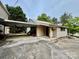 Quaint house with metal roof shows a carport, side door and rock foundation under vinyl siding at 1733 S Nc 16 Business Hwy, Stanley, NC 28164