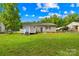 Expansive backyard featuring lush green grass, a deck, and mature trees at 1812 Alpine Dr, Kings Mountain, NC 28086