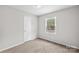 Bright bedroom with plush carpet, window views, and a convenient closet at 1812 Alpine Dr, Kings Mountain, NC 28086