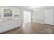 Bright kitchen features neutral paint, white cabinets, wood-look flooring, and a window over the sink at 1812 Alpine Dr, Kings Mountain, NC 28086
