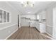 Bright kitchen features white cabinets, wood-look flooring, a chandelier, and a window over the sink at 1812 Alpine Dr, Kings Mountain, NC 28086