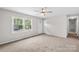 Neutral living room features plush carpet, a ceiling fan, a window, and white trim at 1812 Alpine Dr, Kings Mountain, NC 28086