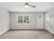 Inviting living room features neutral carpet, a ceiling fan, and a bright window at 1812 Alpine Dr, Kings Mountain, NC 28086