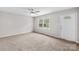 Bright living room with neutral carpet, a ceiling fan, and a large window offering plenty of natural light at 1812 Alpine Dr, Kings Mountain, NC 28086