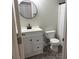 This bathroom features a black faucet, black trimmed mirror, white vanity, toilet and tiled floor at 2015 Downey St, Rock Hill, SC 29732