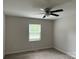 Bright bedroom features neutral walls, plush carpeting, and a ceiling fan for added comfort at 2015 Downey St, Rock Hill, SC 29732