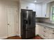 Updated kitchen features stainless steel fridge and white cabinets, with granite countertops and modern hardware at 2015 Downey St, Rock Hill, SC 29732