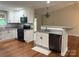 Open kitchen with stainless appliances, granite counters, and breakfast bar for casual dining at 2015 Downey St, Rock Hill, SC 29732