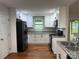 Modern kitchen featuring white cabinets, granite countertops, and stainless steel appliances, a true chef's delight at 2015 Downey St, Rock Hill, SC 29732