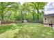 Spacious backyard with well-kept lawn, fire pit, shed, and patio area, ideal for relaxation at 203 Lincoln St, Belmont, NC 28012
