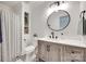 Stylish bathroom with a modern vanity, round mirror, and geometric tile flooring at 203 Lincoln St, Belmont, NC 28012