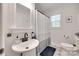 Modern bathroom featuring a pedestal sink, stylish mirror, and patterned tile flooring at 203 Lincoln St, Belmont, NC 28012