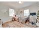 Bright bedroom featuring a comfortable bed, hardwood floors, and a well-lit workspace at 203 Lincoln St, Belmont, NC 28012