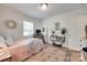Charming bedroom with natural light, wood floors, and a cozy spot for work or study at 203 Lincoln St, Belmont, NC 28012