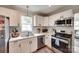 Modern kitchen with stainless steel appliances and white countertops at 203 Lincoln St, Belmont, NC 28012