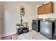 Functional laundry room with gray washer and dryer, stylish rug, and ample storage space at 203 Lincoln St, Belmont, NC 28012