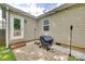 Cozy patio with brick pavers, grill, tiki torches, and string lights for outdoor entertaining at 203 Lincoln St, Belmont, NC 28012