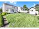 Expansive backyard showing a large, green lawn, with a shed and back of house in the distance at 2210 Winding River Dr, Charlotte, NC 28214