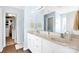 Bright bathroom featuring a double vanity with marble countertops and a large mirror at 2210 Winding River Dr, Charlotte, NC 28214