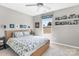 Bright bedroom features a bed, ceiling fan, and natural light from a large window at 2210 Winding River Dr, Charlotte, NC 28214