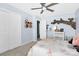 Bright bedroom featuring a fan, closet and view into the hallway at 2210 Winding River Dr, Charlotte, NC 28214