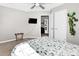 Bedroom with ceiling fan, TV, luggage rack, and view into the hallway at 2210 Winding River Dr, Charlotte, NC 28214