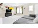 Bright bonus room featuring neutral walls, carpet, TV, and a comfortable gray sectional sofa at 2210 Winding River Dr, Charlotte, NC 28214